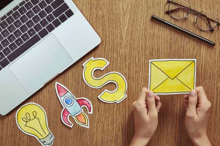 cropped image of woman holding message sign at table in room - how to grow your email list